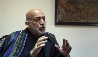 Former Afghan President Hamid Karzai speaks during an interview with The Associated Press in Kabul, Afghanistan, Thursday, Nov. 1, 2018. Karzai said Thursday that he sees a role for the Taliban in his country after the war -- in a future, peaceful Afghanistan. Karzai also said that five Taliban leaders who were freed from the U.S. military prison at Guantanamo Bay in exchange for American army Sgt. Bowe Bergdahl are “good individuals, good Afghans” who should have a role in peace negotiations. (AP Photo/Rahmat Gul)