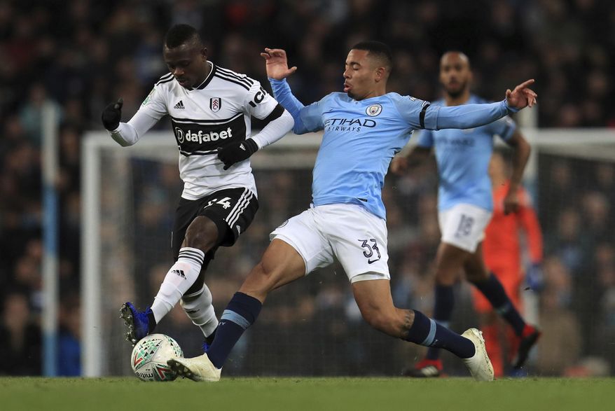 Fulham&#39;s Jean Michael Seri and Manchester City&#39;s Gabriel Jesus, right, during their English League Cup, Fourth Round match at the Etihad Stadium in Manchester, England, Thursday Nov. 1, 2018. (Mike Egerton/PA via AP)