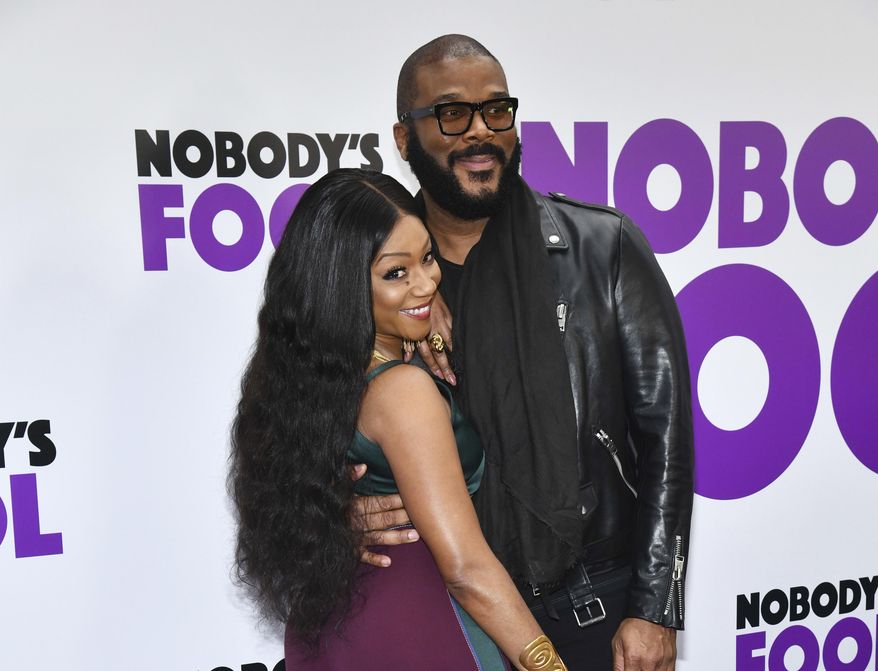 FILE - In this Oct. 28, 2018 file photo, Tiffany Haddish and Tyler Perry attend the world premiere of "Nobody's Fool" in New York. Haddish has a goal to make 50 movies by her 50th birthday. She says she also wants to keep expectations reasonable adding that ‘they’re not all gonna be great.’ She insists her latest movie, ‘Nobody’s Fool,’ written, directed and produced by Perry is one of the good ones. (Photo by Charles Sykes/Invision/AP, File)