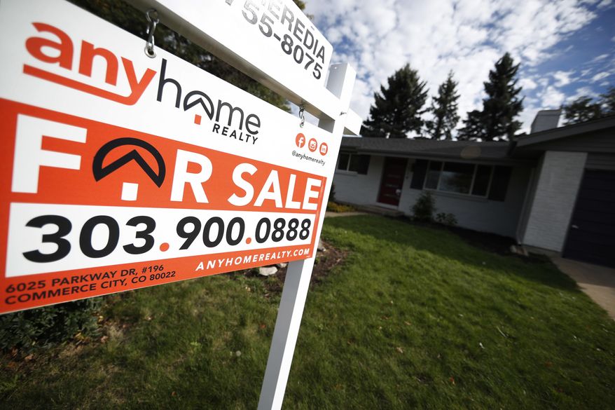 FILE- In this Oct 2, 2018, file photo a for sale sign stands outside a home on the market in the north Denver suburb of Thornton, Colo. On Thursday, Nov. 1, Freddie Mac reports on this week’s average U.S. mortgage rates. (AP Photo/David Zalubowski, File)