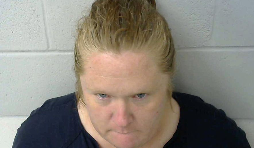 This photo provided by the Okmulgee County Jail in Okmulgee, Okla., shows Amy Leann Hall, who is in custody after three teenagers were shot, one fatally in a shooting reported Thursday morning, Nov. 1, 2018, in the Nuyaka, Okla., area. Authorities believe Hall is the mother of the children. She's currently being held in the Okmulgee County jail on preliminary charges of one count of first-degree murder and two counts of shooting with intent to kill, though formal charges have not yet been filed. (Okmulgee County Jail via AP)