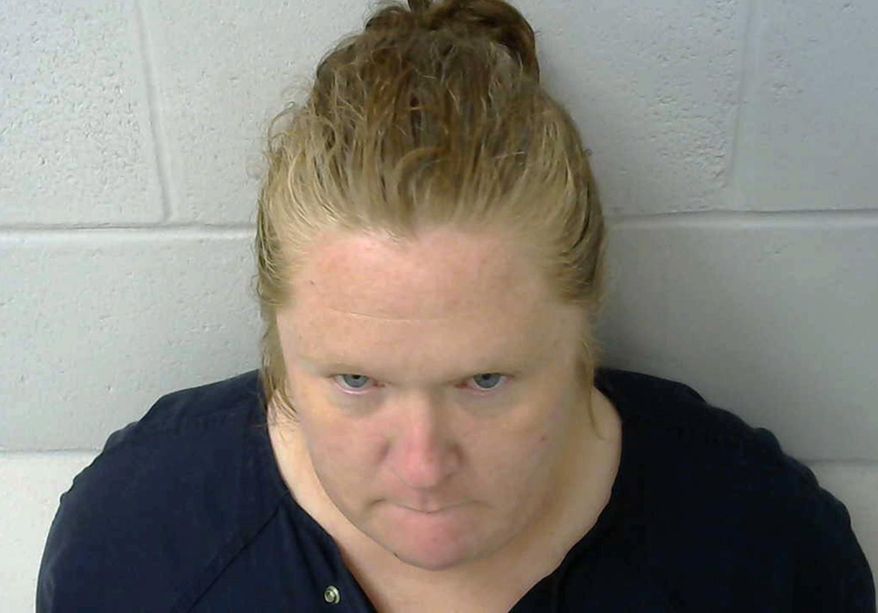 This photo provided by the Okmulgee County Jail in Okmulgee, Okla., shows Amy Leann Hall, who is in custody after three teenagers were shot, one fatally in a shooting reported Thursday morning, Nov. 1, 2018, in the Nuyaka, Okla., area. Authorities believe Hall is the mother of the children. She's currently being held in the Okmulgee County jail on preliminary charges of one count of first-degree murder and two counts of shooting with intent to kill, though formal charges have not yet been filed. (Okmulgee County Jail via AP)