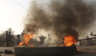Pakistani protesters burn tires while blocking a main road during a protest after a court decision, in Karachi, Pakistan, Thursday, Nov. 1, 2018.  Asia Bibi, a Christian woman who spent eight years on death row under Pakistan&#39;s blasphemy law was acquitted and ordered released Wednesday by the country&#39;s top court, a ruling that raised fears of violence by religious extremists who held angry protests over the verdict.(AP Photo/Shakil Adil)