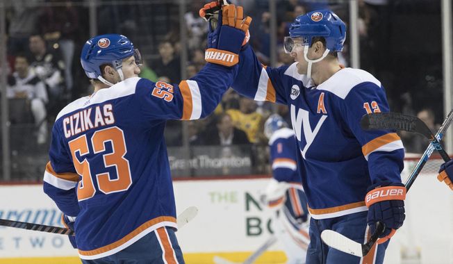 New York Islanders right wing Josh Bailey (12) celebrates scoring a goal with center Casey Cizikas (53) during the second period of an NHL hockey game against the Pittsburgh Penguins, Thursday, Nov. 1, 2018, in New York. (AP Photo/Mary Altaffer)