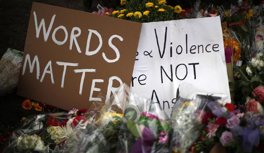 Flowers surround signs on Wednesday, Oct. 31, 2018, part of a makeshift memorial outside the Tree of Life Synagogue to the 11 people killed during worship services Saturday Oct. 27, 2018 in Pittsburgh. (AP Photo/Gene J. Puskar)