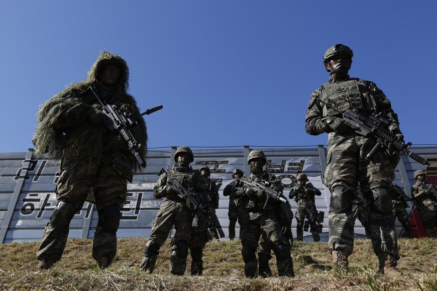 South Korean marines stand in attention during their regular drill on Yeonpyeong Island, South Korea Thursday, Nov. 1, 2018. The U.S. and South Korea are reviewing whether they will conduct large-scale military exercises next year and will decide before December. South Korean Defense Minister Jeong Kyeong-doo told reporters Wednesday at the Pentagon that if more exercises are suspended the two countries will conduct other training to mitigate the lapse. He says the review will be done by Nov. 15. (Jeon Heon-kyun/Pool Photo via AP) **FILE**