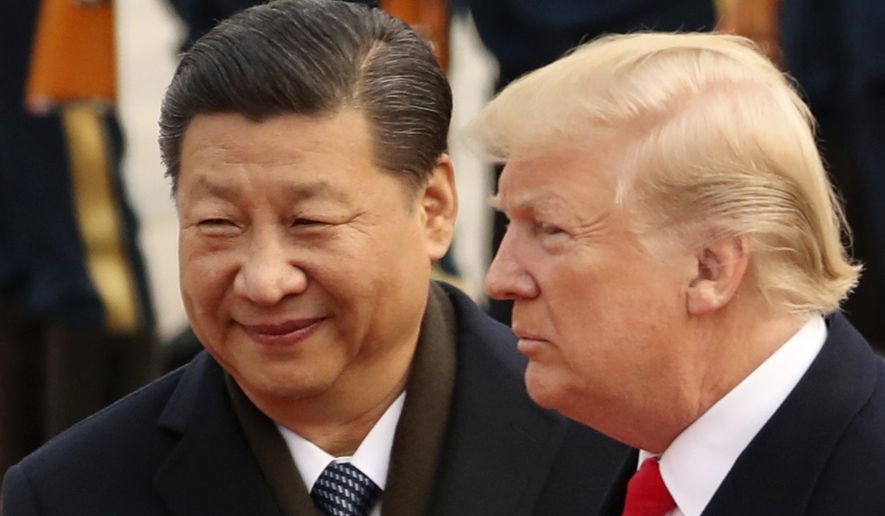 In this Nov. 9, 2017, photo, U.S. President Donald Trump and Chinese President Xi Jinping participate in a welcome ceremony at the Great Hall of the People in Beijing, China. Mr. Xi had an &quot;extremely positive&quot; phone conversation with Mr. Trump about trade and other issues, the foreign ministry said Friday, Nov. 2, 2018. The two leaders agreed to &quot;strengthen economic exchanges,&quot; said a ministry spokesman, Lu Kang. (AP Photo/Andrew Harnik, File)