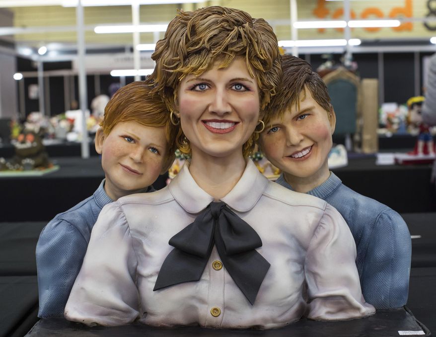 A cake in the likeness of Princess Diana, with sons Prince Harry, left, and Prince William on display during Cake International, The Sugarcraft, Cake Decorating and Baking Show, at the NEC in Birmingham, England, Friday Nov. 2, 2018. The show runs until Nov. 4. (Aaron Chown/PA via AP)