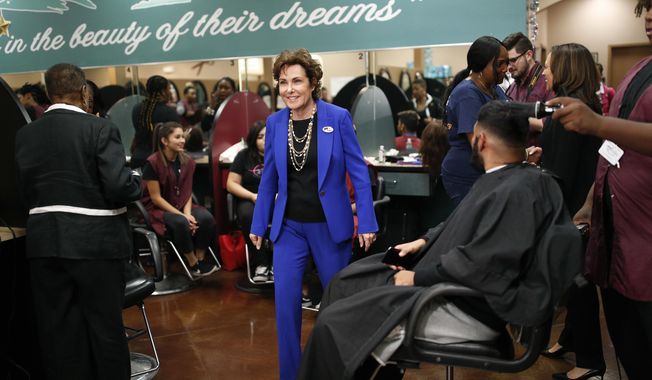 Rep. Jacky Rosen, D-Nev., center, walks through the Expertise Cosmetology Institute during an event for her Senate campaign, Friday, Nov. 2, 2018, in Las Vegas. Battleground races for U.S. Senate, U.S. House and governor will make Nevada voters Tuesday a key decider of power in Congress and the state’s political landscape for a decade. (AP Photo/John Locher)