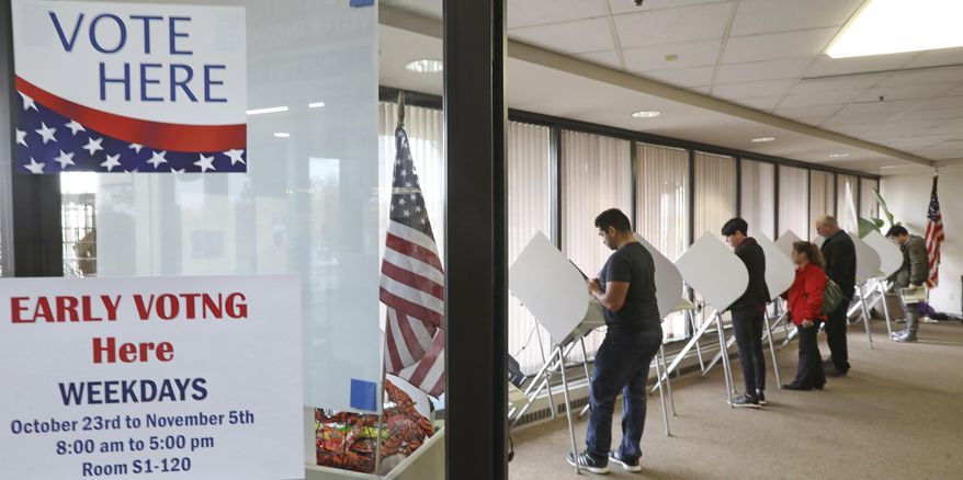 In this Wednesday, Oct. 31, 2018, photo, voters cast their votes in Salt Lake City. If a Utah race is too close to call on election night a distinct possibility in the slugfest between Republican Rep. Mia Love and Democrat Ben McAdams residents and candidates will have to wait patiently because the state's deliberate vote release schedule recommends counties wait three days before posting more results. (AP Photo/Rick Bowmer)