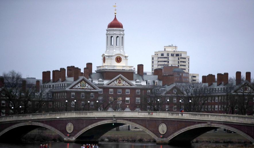 In this March 7, 2017, file photo, rowers paddle down the Charles River past the campus of Harvard University in Cambridge, Mass. (AP Photo/Charles Krupa, File)