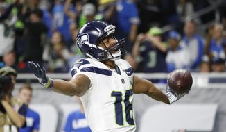Seattle Seahawks wide receiver Tyler Lockett reacts after his 24-yard reception for a touchdown during the first half of an NFL football game against the Detroit Lions, Sunday, Oct. 28, 2018, in Detroit. (AP Photo/Duane Burleson)