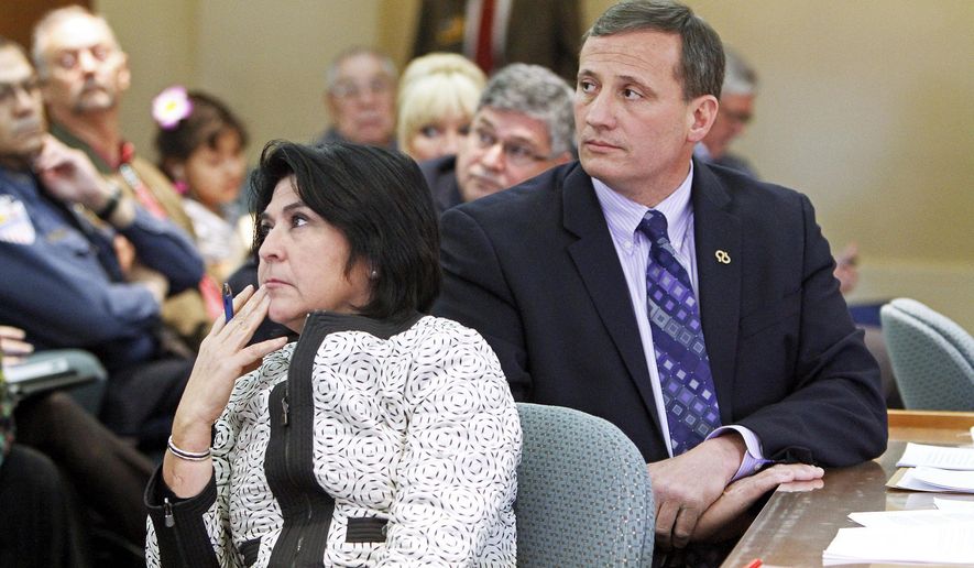 FILE - In this Feb. 8, 2014 file photo, Demesia Padilla, the former Cabinet Secretary with State Revenue and Taxation Department, left, and former Rep. Paul Pacheco, R-Albuquerque, listen to the audiences during a committee meeting at the New Mexico State Capitol in Santa Fe. Padilla on Thursday, June 28, 2018 was charged with embezzlement, and multiple corruption and ethics violations stemming from her time as Cabinet secretary. Former Taxation and Revenue Department secretary Padilla is scheduled to appear Monday, Oct. 27, 2018, in state court for a hearing on whether evidence is sufficient for a trail to go forward. (Jane Phillips/The Santa Fe New Mexican via AP, File)