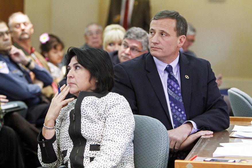 FILE - In this Feb. 8, 2014 file photo, Demesia Padilla, the former Cabinet Secretary with State Revenue and Taxation Department, left, and former Rep. Paul Pacheco, R-Albuquerque, listen to the audiences during a committee meeting at the New Mexico State Capitol in Santa Fe. Padilla on Thursday, June 28, 2018 was charged with embezzlement, and multiple corruption and ethics violations stemming from her time as Cabinet secretary. Former Taxation and Revenue Department secretary Padilla is scheduled to appear Monday, Oct. 27, 2018, in state court for a hearing on whether evidence is sufficient for a trail to go forward. (Jane Phillips/The Santa Fe New Mexican via AP, File)