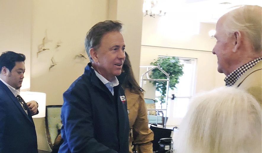 In this Wednesday, Oct. 31, 2018, file photo, Democratic candidate for governor Ned Lamont greets people during a campaign stop in Mystic, Conn. (AP Photo/Susan Haigh)