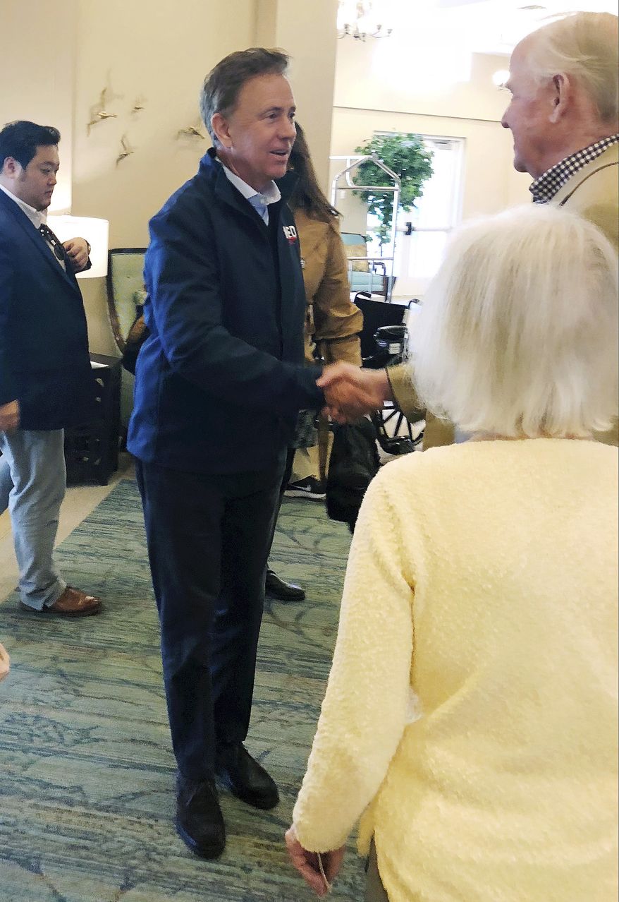 In this Wednesday, Oct. 31, 2018, file photo, Democratic candidate for governor Ned Lamont greets people during a campaign stop in Mystic, Conn. (AP Photo/Susan Haigh)