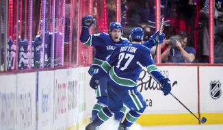 Vancouver Canucks&#39; Markus Granlund, back, of Finland, and Ben Hutton celebrate Granlund&#39;s goal against the Colorado Avalanche during the third period of an NHL hockey game Friday, Nov. 2, 2018, in Vancouver, British Columbia. (Darryl Dyck/The Canadian Press via AP)