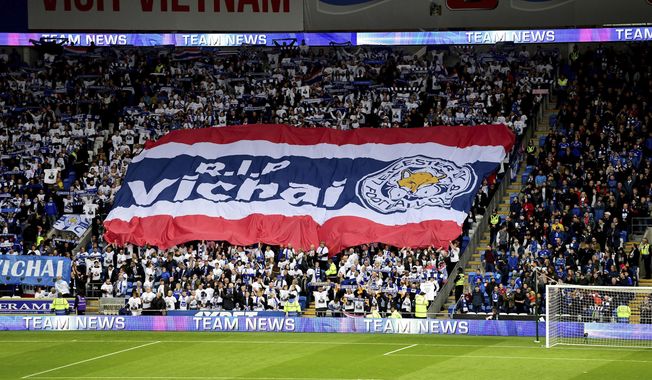Leicester City fans with a giant banner that reads &#x27;RIP Vichai&#x27; during the English Premier League soccer match between Cardiff City and Leicester City at the Cardiff City Stadium, Cardiff. Wales. Saturday Nov. 3, 2018. (Simon Galloway/PA via AP)