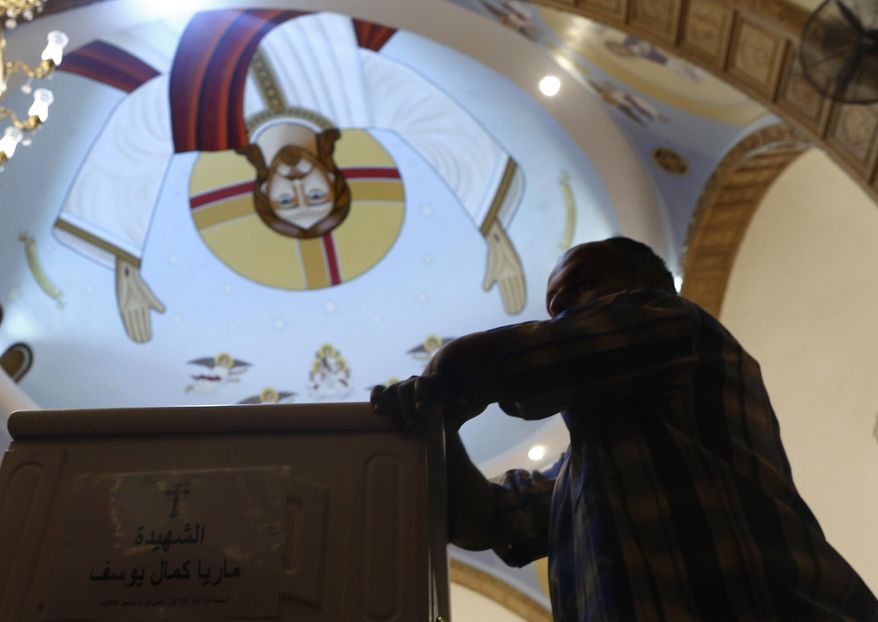 FILE - A relative of a killed Coptic Christian grieves during a funeral at Church of Great Martyr Prince Tadros, in Minya, Egypt, Saturday, Nov. 3, 2018. Coptic Christians in the Egyptian town of Minya prepared to bury their dead, a day after militants ambushed three buses carrying Christian pilgrims on their way to a remote desert monastery. (AP Photo/Amr Nabil)