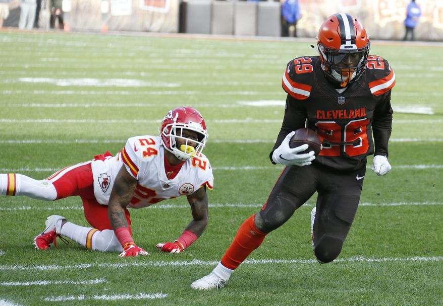 Cleveland Browns running back Duke Johnson (29) breaks free from Kansas City Chiefs strong safety Jordan Lucas (24) for a 19-yard touchdown during the first half of an NFL football game, Sunday, Nov. 4, 2018, in Cleveland. (AP Photo/Ron Schwane)