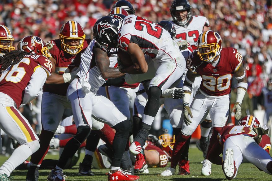Atlanta Falcons running back Ito Smith (25) leaps toward the end zone for a touchdown during the first half of an NFL football game against the Washington Redskins, Sunday, Nov. 4, 2018, in Landover, Md. (AP Photo/Pablo Martinez Monsivais)