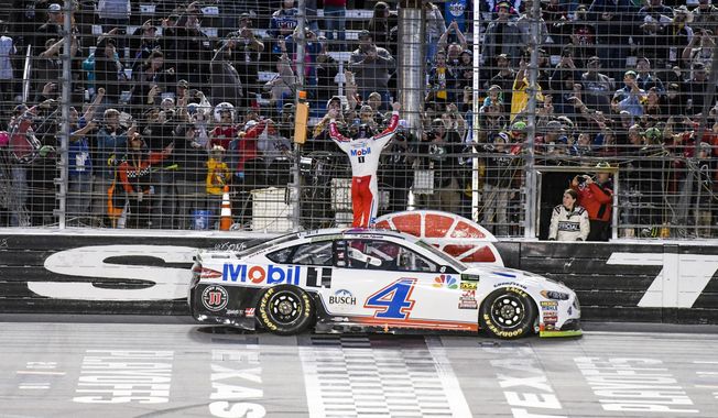 Kevin Harvick celebrates with fans after winning a NASCAR Cup auto race at Texas Motor Speedway, Sunday, Nov. 4, 2018, in Fort Worth, Texas. (AP Photo/Larry Papke) **FILE**
