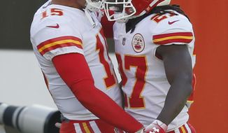Kansas City Chiefs running back Kareem Hunt (27) celebrates with quarterback Patrick Mahomes (15) after a 50-yard touchdown during the first half of an NFL football game against the Cleveland Browns, Sunday, Nov. 4, 2018, in Cleveland. (AP Photo/Ron Schwane)