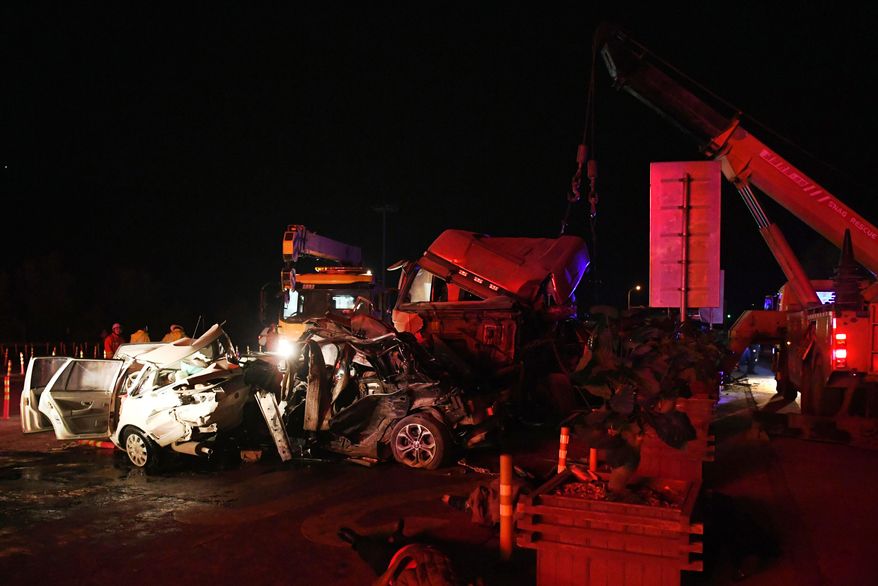 In this Saturday, Nov. 3, 2018, photo released by China's Xinhua News Agency, the aftermath of a highway accident is seen in Lanzhou in northwestern China's Gansu province. Authorities say more than a dozen people have been killed in a highway pile-up on Saturday night after a heavy truck lost control and crashed into a line of vehicles waiting at a toll station. (Chen Bin/Xinhua via AP)