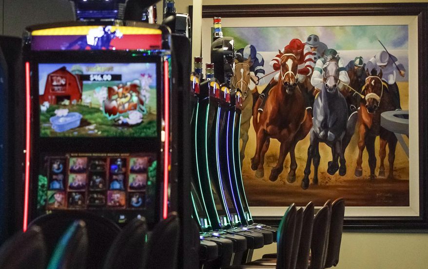 FILE - This March 5, 2015 file photo shows video gaming terminals known as instant horse racing at Les Bois Park in Garden City, Idaho. Such machines are now banned in Idaho, but a new ballot initiative, Proposition 1, has been filed to legalize the machines. (AP Photo/Otto Kitsinger, File)