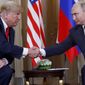 President Donald Trump and Russian President Vladimir Putin shake hands at the beginning of a meeting at the Presidential Palace in Helsinki, Finland. (AP Photo/Pablo Martinez Monsivais, File)