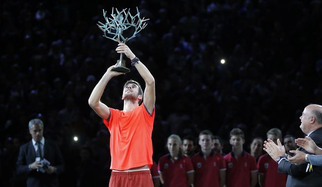 Karen Khachanov of Russia raises the trophy after defeating Novak Djokovic of Serbia in their final match of the Paris Masters tennis tournament at the Bercy Arena in Paris, France, Sunday, Nov. 4, 2018. (AP Photo/Michel Euler)