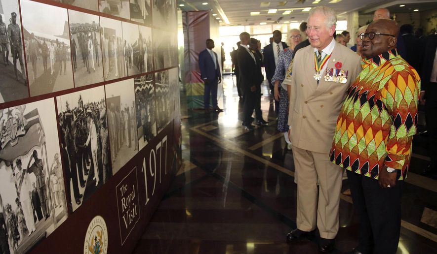 Prince Charles, left, and Ghana's President, Nana Akufo-Addo, look at memorial photos at the Jubilee House in Accra, Ghana, Friday, Nov. 2, 2018. Prince Charles and his wife Camilla, the Duchess of Cornwall, have arrived in Ghana for the second stop of their West African tour.(AP Photo)