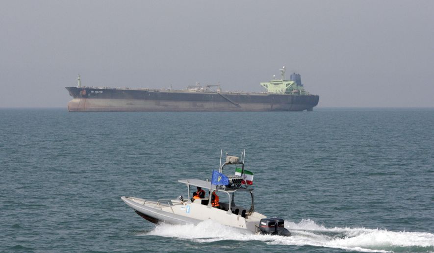 In this July 2, 2012, file photo, an Iranian Revolutionary Guard speedboat moves in the Persian Gulf while an oil tanker is seen in background. (AP Photo/Vahid Salemi, File)