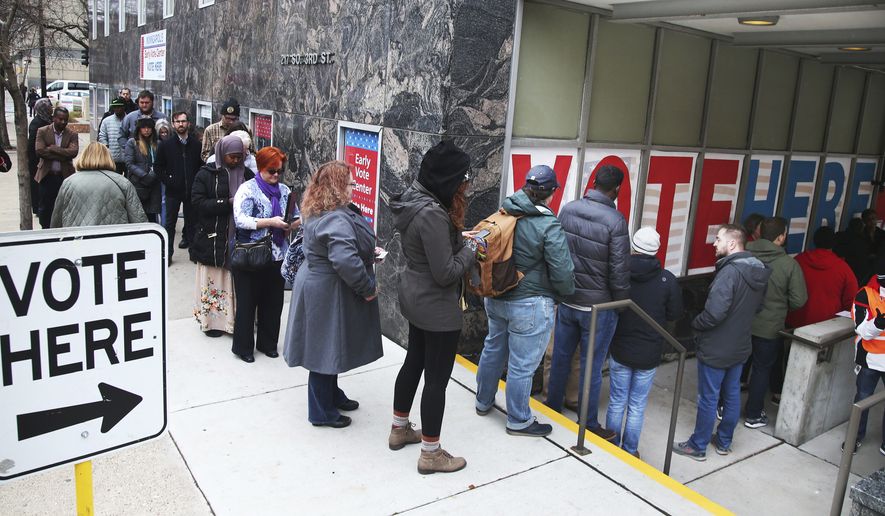 People line up to vote on the last day of early voting at the Minneapolis Early Vote Center Monday, Nov. 5, 2018, in Minneapolis. (AP Photo/Jim Mone)