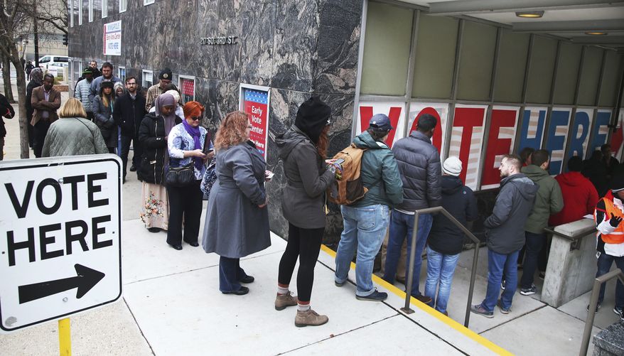 People line up to vote on the last day of early voting at the Minneapolis Early Vote Center Monday, Nov. 5, 2018, in Minneapolis. (AP Photo/Jim Mone)