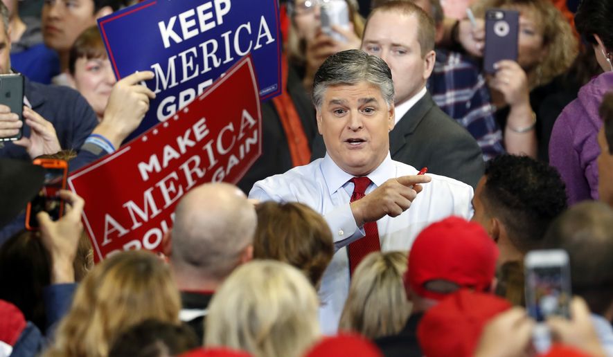 Television personality Sean Hannity speaks to members of the audience while signing autographs before the start of a campaign rally Monday, Nov. 5, 2018, in Cape Girardeau, Mo., with President Donald Trump. (AP Photo/Jeff Roberson)