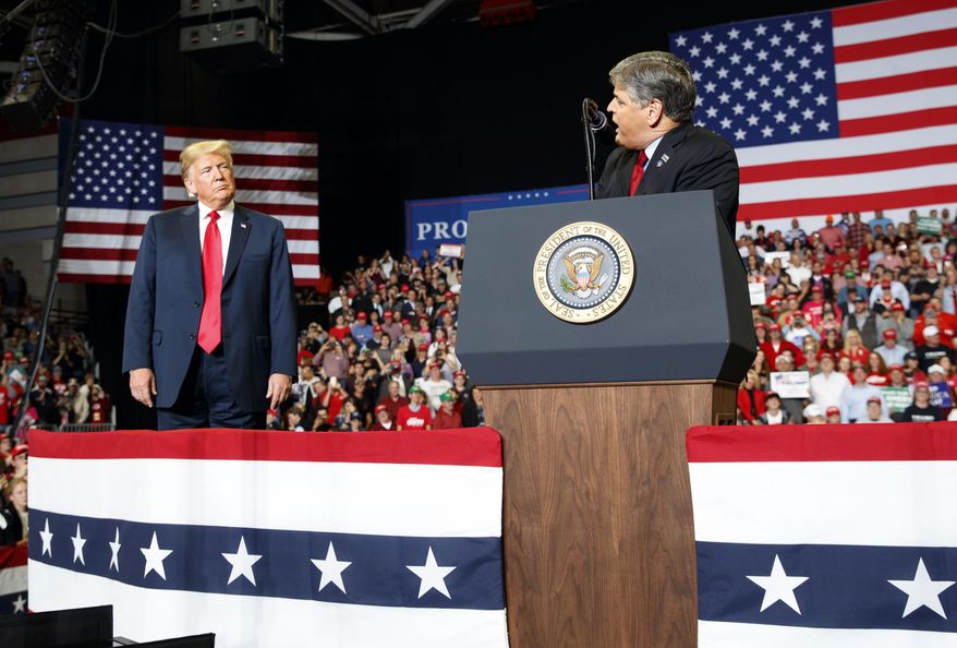 President Donald Trump listens Fox News&#39; Sean Hannity speak during a rally at Show Me Center, Monday, Nov. 5, 2018, in Cape Girardeau, Mo.. (AP Photo/Carolyn Kaster)