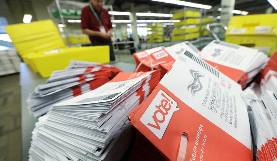 FILE - In this Aug. 7, 2018 file photo, empty envelopes from Washington state's primary election are shown stacked at King County Election headquarters in Renton, Wash. The crowded Washington state ballot for Tuesday's Nov. 6, 2018 election includes four initiatives, 10 congressional races, a U.S. Senate seat and more than 100 legislative contests. (AP Photo/Ted S. Warren, File)