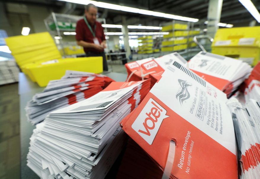 FILE - In this Aug. 7, 2018 file photo, empty envelopes from Washington state's primary election are shown stacked at King County Election headquarters in Renton, Wash. The crowded Washington state ballot for Tuesday's Nov. 6, 2018 election includes four initiatives, 10 congressional races, a U.S. Senate seat and more than 100 legislative contests. (AP Photo/Ted S. Warren, File)