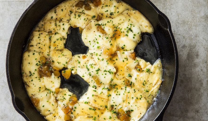 This undated photo provided by America's Test Kitchen in October 2018 shows baked brie with honeyed apricots in Brookline, Mass. This recipe appears in the cookbook "All-Time Best Appetizers." (Joe Keller/America's Test Kitchen via AP)