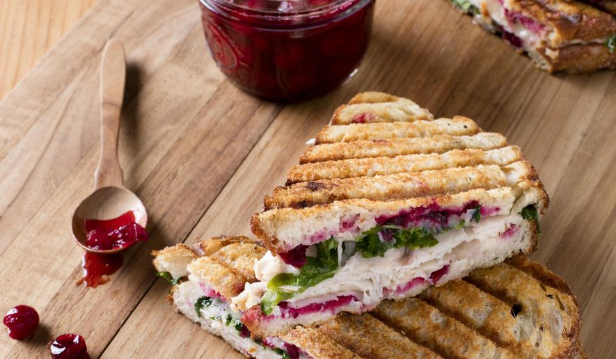This undated photo provided by America's Test Kitchen in October 2018 shows smoked turkey panini with simple cranberry sauce in Brookline, Mass. This recipe appears in the cookbook "Just Add Sauce." (Steve Klise/America's Test Kitchen via AP)