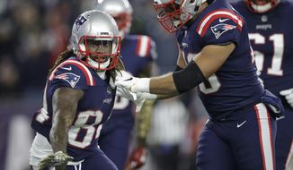 New England Patriots wide receiver Cordarrelle Patterson, left, celebrates his touchdown run teammates during the first half of an NFL football game against the Green Bay Packers, Sunday, Nov. 4, 2018, in Foxborough, Mass. (AP Photo/Charles Krupa)