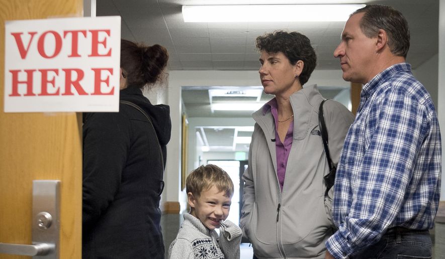 Democratic congressional candidate Amy McGrath stands in line with her family while waiting to vote on Election Day in Georgetown, Ky., Tuesday, Nov. 6, 2018. (AP Photo/Bryan Woolston) ** FILE **