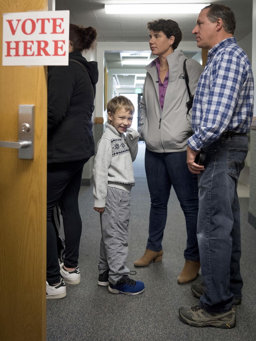 Democratic congressional candidate Amy McGrath stands in line with her family while waiting to vote on Election Day in Georgetown, Ky., Tuesday, Nov. 6, 2018. (AP Photo/Bryan Woolston) ** FILE **
