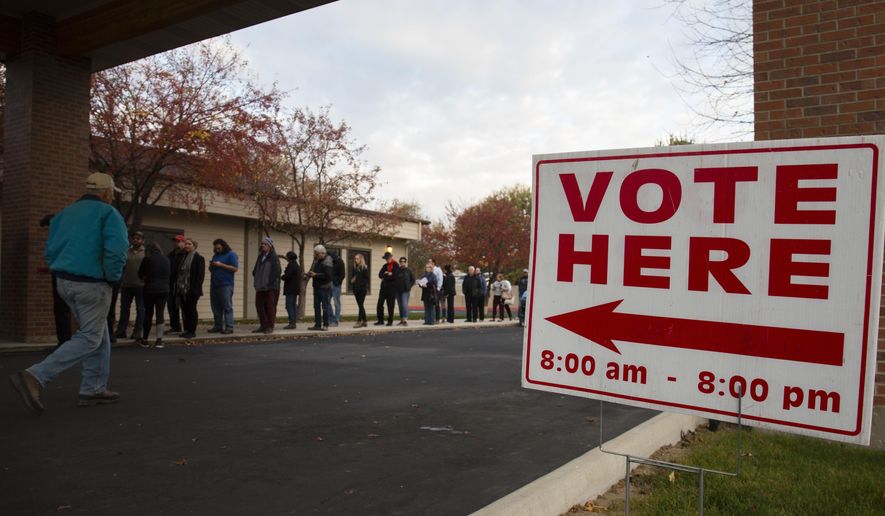Voters wait in line as the polls open at Pierce Park Baptist Church in Boise, Idaho, Tuesday, Nov. 6, 2018. (AP Photo/Otto Kitsinger)