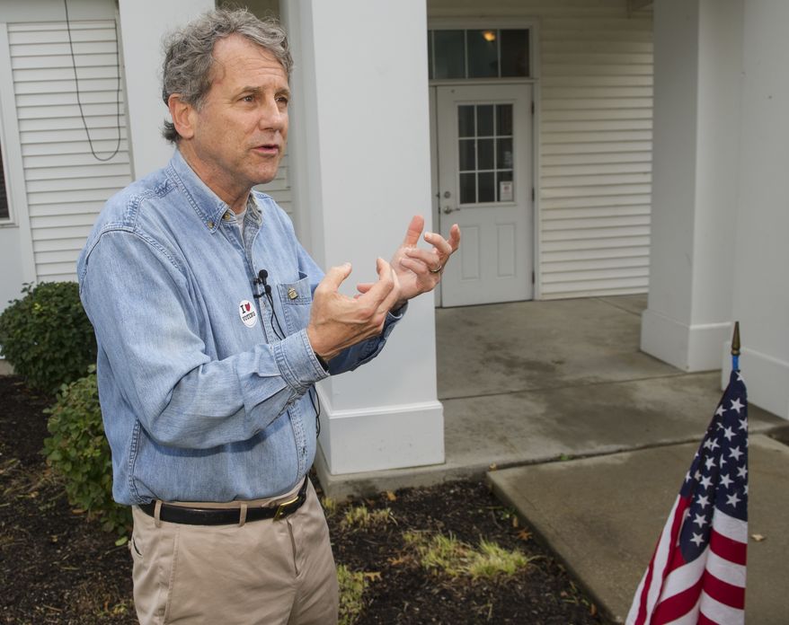 Sen. Sherrod Brown, D-Ohio, talks with reporters after voting Tuesday, Nov. 6, 2018, in Cleveland. (AP Photo/Phil Long)
