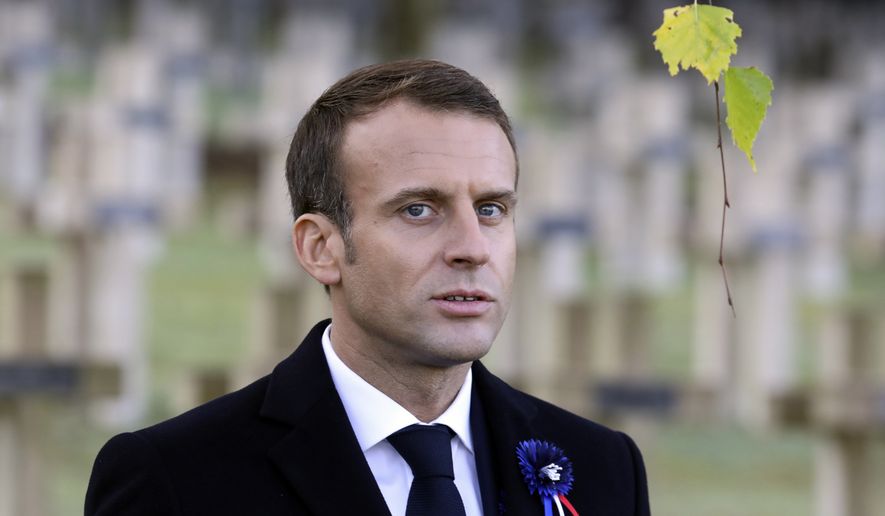 French President Emmanuel Macron arrives to pay his respect by the tomb of Lieutenant Robert Porchon, brother-in-arms of French writer Maurice Genevoix killed during World War I, at the Trottoir necropolis in Les Eparges, eastern France, Tuesday Nov. 6, 2018, as part of the ceremonies marking the centenary of the First World War. (Ludovic Marin, Pool via AP)