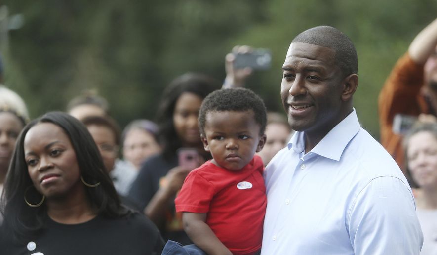 Florida Gubernatorial Democratic candidate Mayor Andrew Gillum takes questions from the press while his wife R. Jai Gillum, and children look on after casting their ballots at the Good Shepherd Catholic Church Precinct in Tallahassee, Florida on Tuesday, November 6, 2018. (Octavio Jones/The Tampa Bay Times via AP) **FILE**