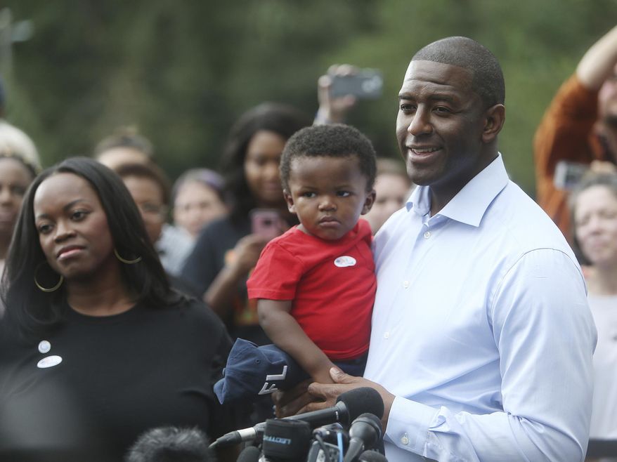 Florida Gubernatorial Democratic candidate Mayor Andrew Gillum takes questions from the press while his wife R. Jai Gillum, and children look on after casting their ballots at the Good Shepherd Catholic Church Precinct in Tallahassee, Florida on Tuesday, November 6, 2018. (Octavio Jones/The Tampa Bay Times via AP) **FILE**