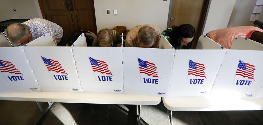 Every voting booth was filled by Madison County voters Tuesday, Nov. 6, 2018, as they filled out their paper ballots in Ridgeland, Miss. Voters have a number of races to consider, including judiciary and federal offices and some local issues. (AP Photo/Rogelio V. Solis)